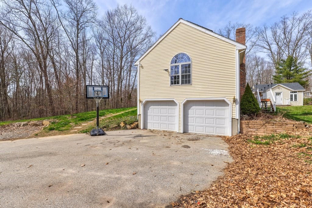 53 Baker Pond Road Charlton, MA 01507 - Photo 3 of 27 a view of a house with a yard and garage