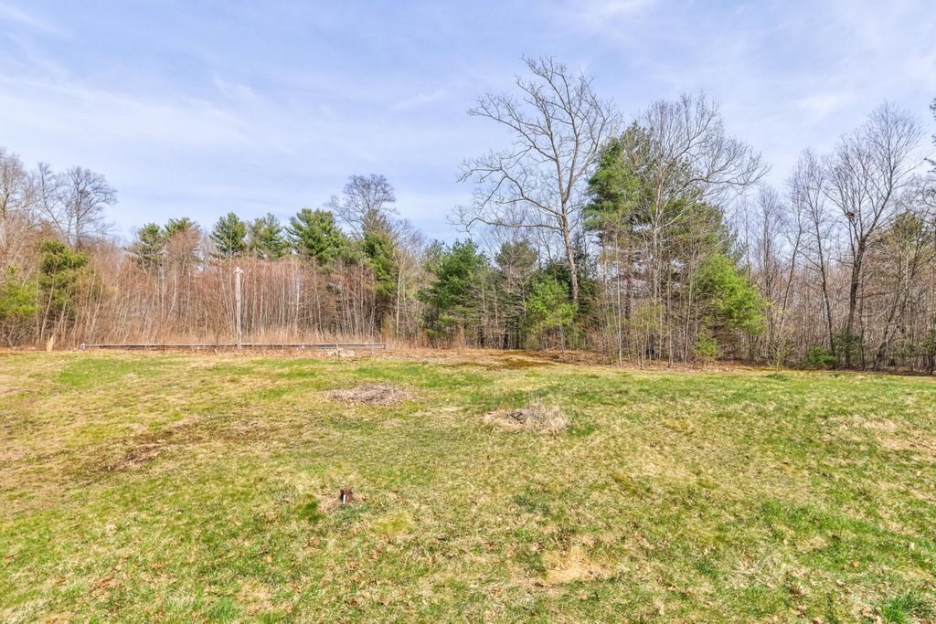 53 Baker Pond Road Charlton, MA 01507 - Photo 4 of 27 a swimming pool with trees in the background
