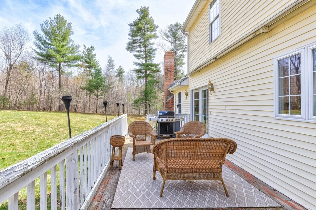 53 Baker Pond Road Charlton, MA 01507 - Photo 6 of 27 a balcony with table and chairs