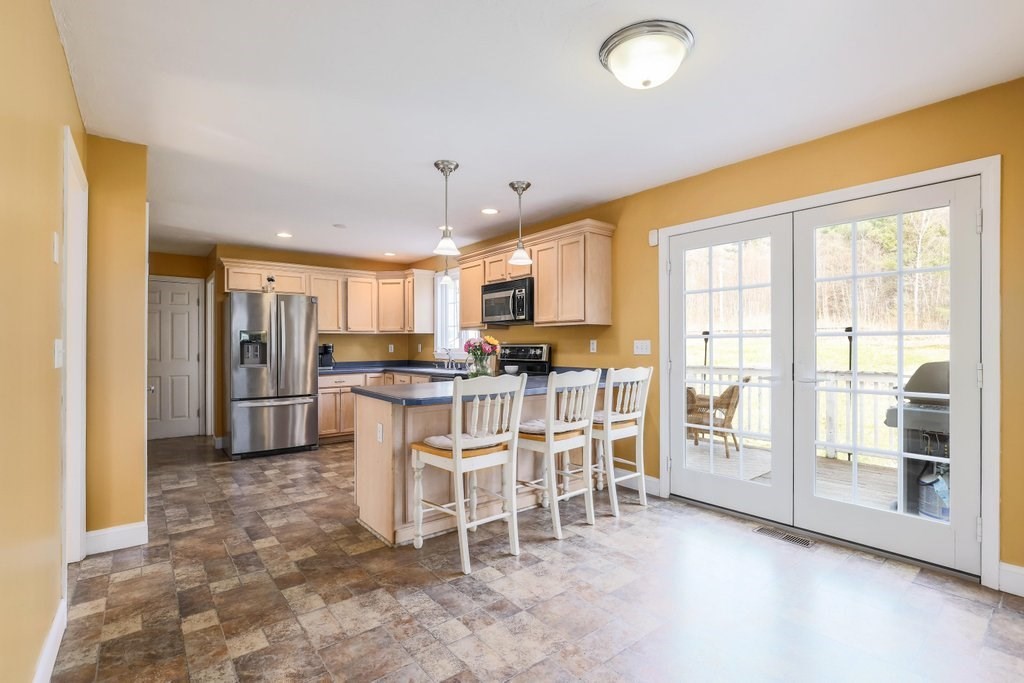 53 Baker Pond Road Charlton, MA 01507 - Photo 9 of 27 a view of a kitchen with dining area and chandelier