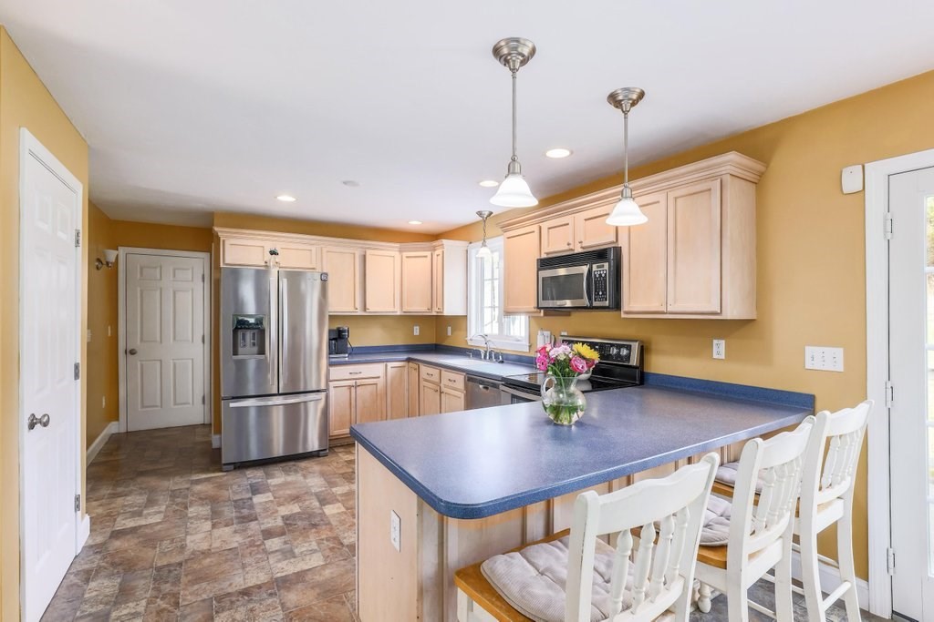 53 Baker Pond Road Charlton, MA 01507 - Photo 10 of 27 a kitchen with stainless steel appliances granite countertop a sink refrigerator and microwave