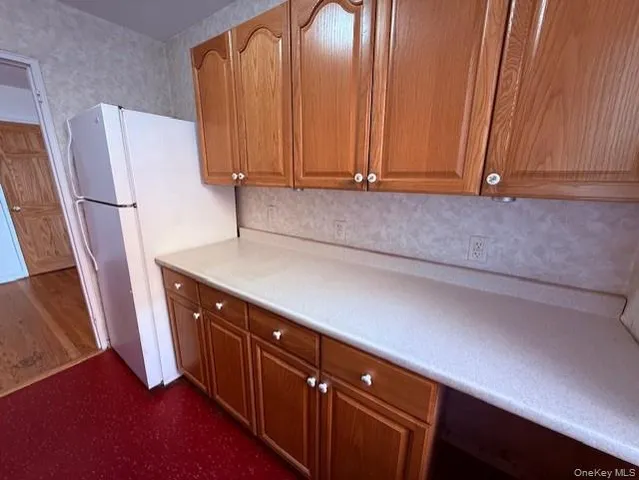 a kitchen with a sink and a refrigerator