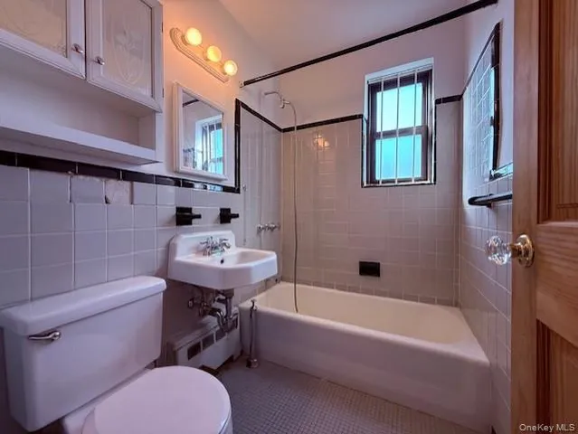 a bathroom with a sink a toilet and bathtub