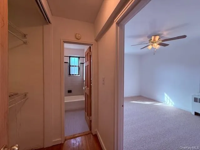 a view of a hallway with wooden floor