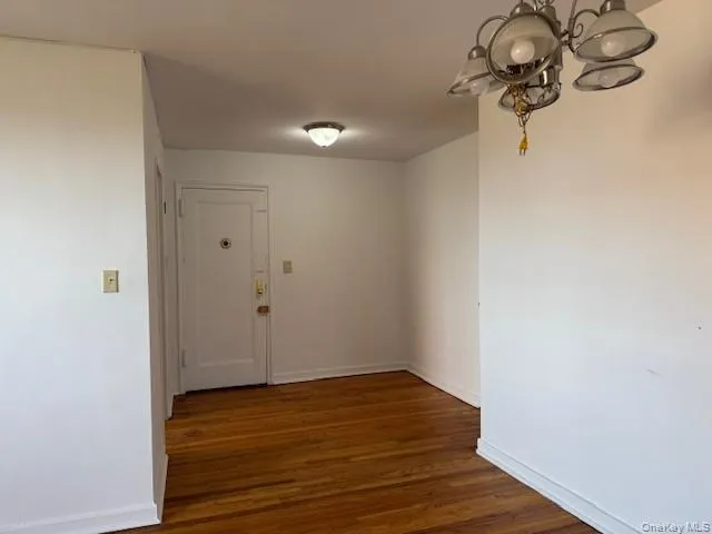 a view of a room with wooden floor
