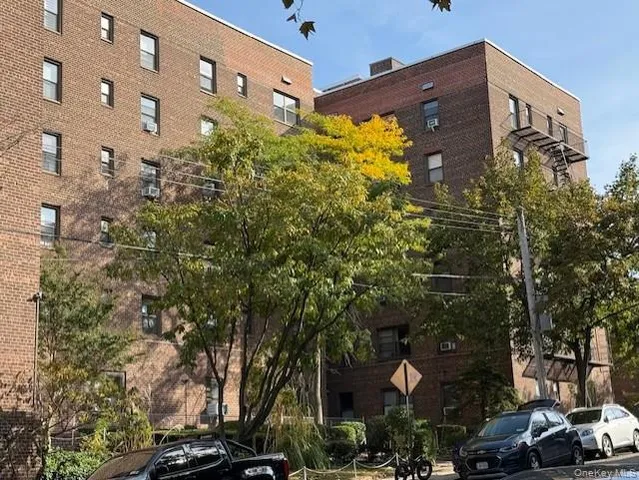 a couple of cars parked in front of a building
