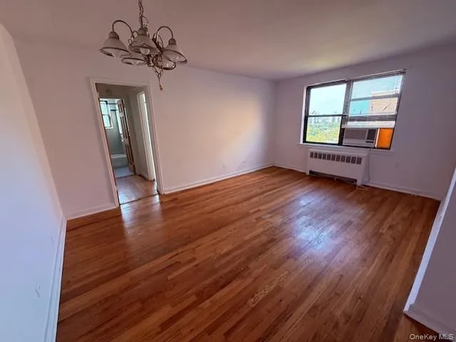 a view of wooden floor and windows in a room