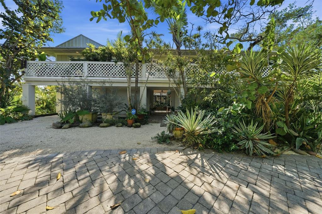 700 Lands End Drive Longboat Key, FL 34228 - Photo 2 of 70 a front view of a house with garden