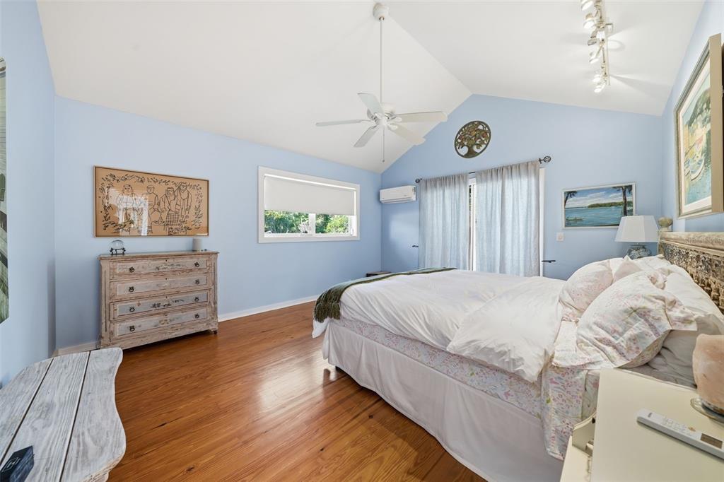 700 Lands End Drive Longboat Key, FL 34228 - Photo 23 of 70 a bedroom with a bed and wooden floor