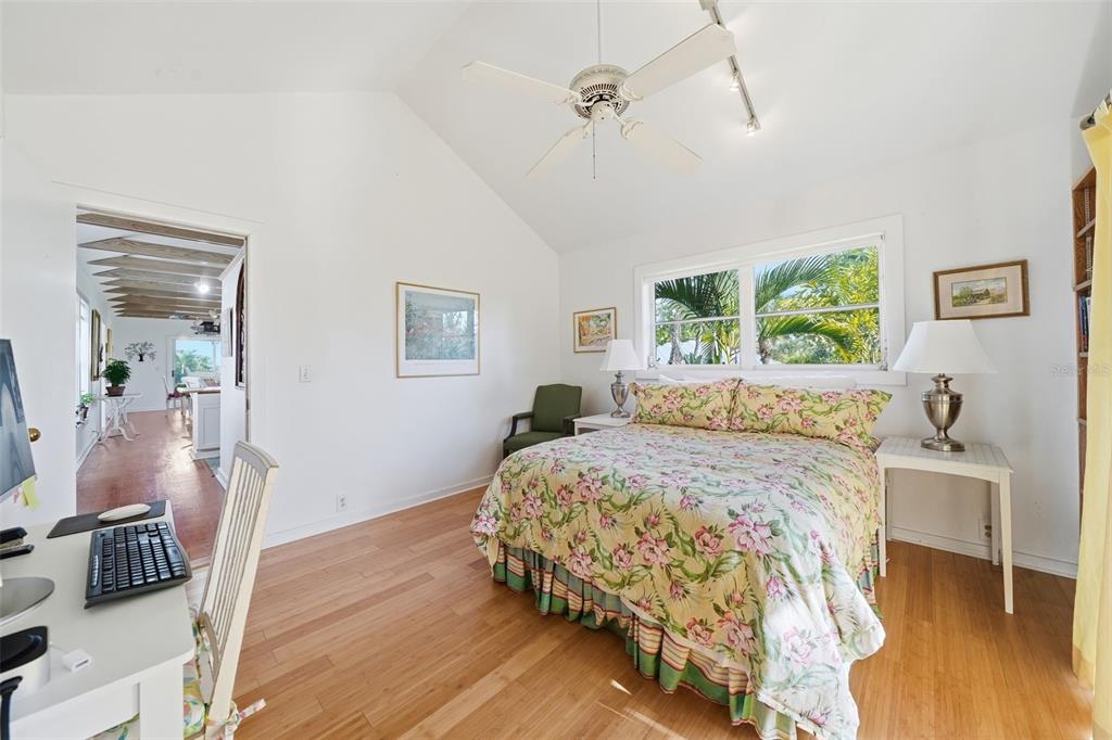 700 Lands End Drive Longboat Key, FL 34228 - Photo 28 of 70 a bedroom with a bed wooden floor and window
