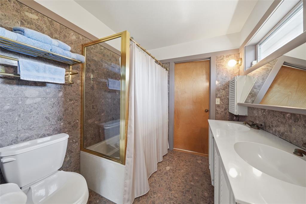 700 Lands End Drive Longboat Key, FL 34228 - Photo 30 of 70 a bathroom with a granite countertop sink toilet and shower