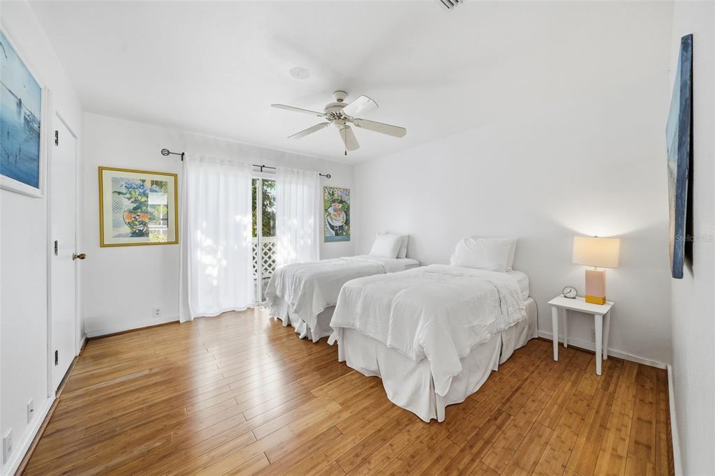 700 Lands End Drive Longboat Key, FL 34228 - Photo 32 of 70 a bedroom with a bed and wooden floor