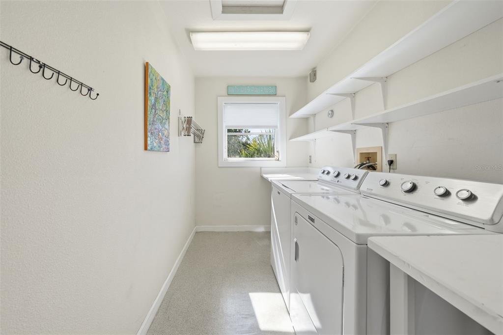 700 Lands End Drive Longboat Key, FL 34228 - Photo 37 of 70 a utility room with cabinets washer and dryer