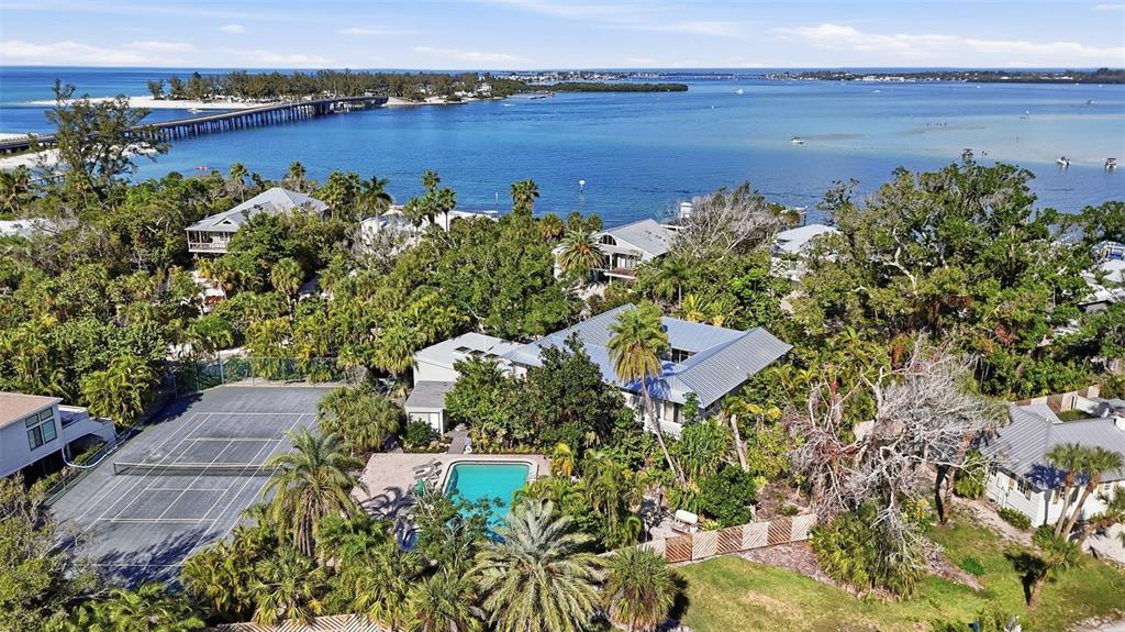 700 Lands End Drive Longboat Key, FL 34228 - Photo 65 of 70 an aerial view of a house with a yard and lake view