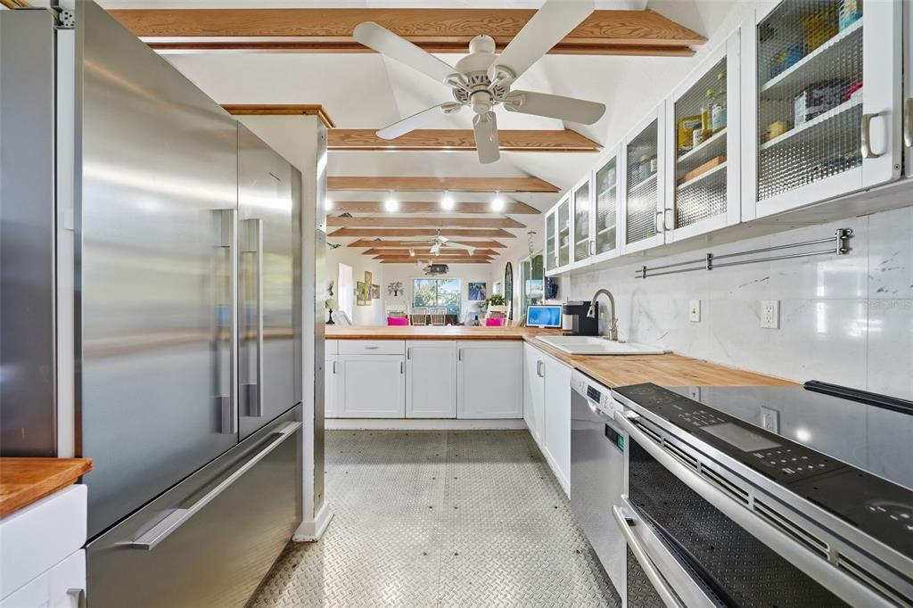 700 Lands End Drive Longboat Key, FL 34228 - Photo 8 of 70 a kitchen with stainless steel appliances a refrigerator and a stove