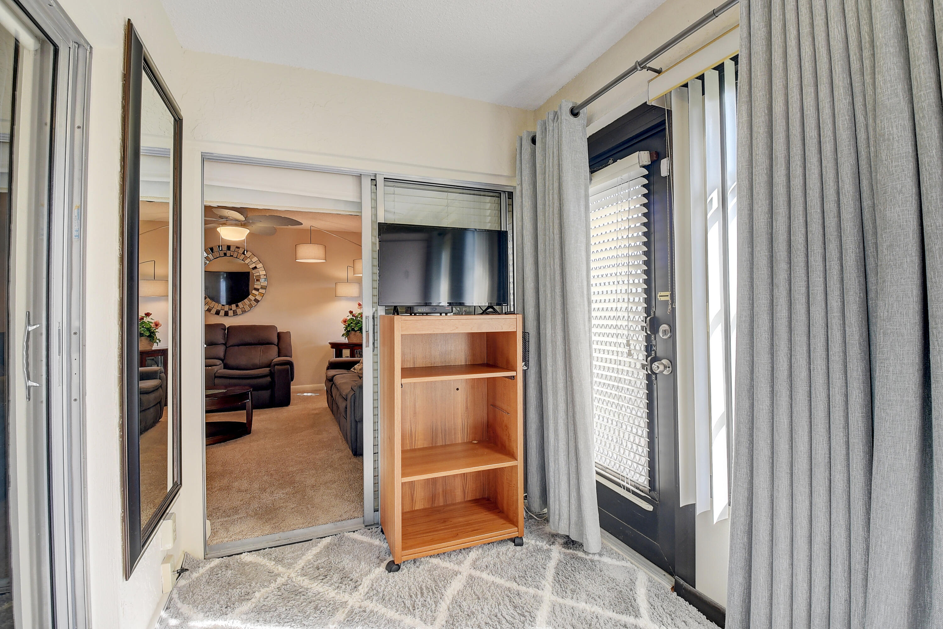 8936 Rheims Road Boca Raton, FL 33496 - Photo 12 of 42 a view of a hallway and a livingroom with a chair