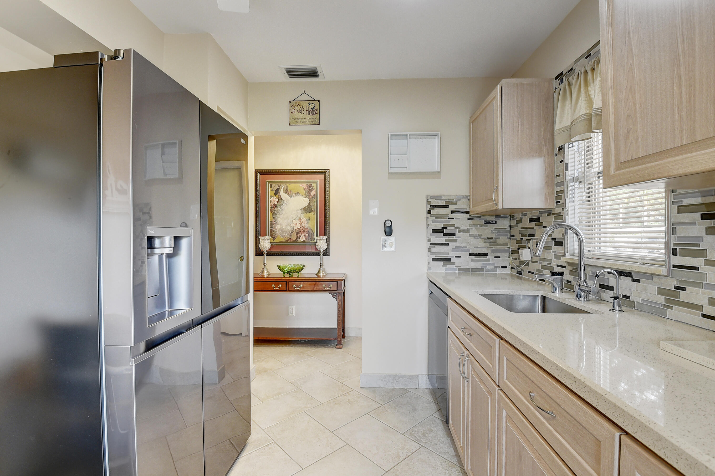 8936 Rheims Road Boca Raton, FL 33496 - Photo 14 of 42 a kitchen with stainless steel appliances granite countertop a refrigerator and a sink