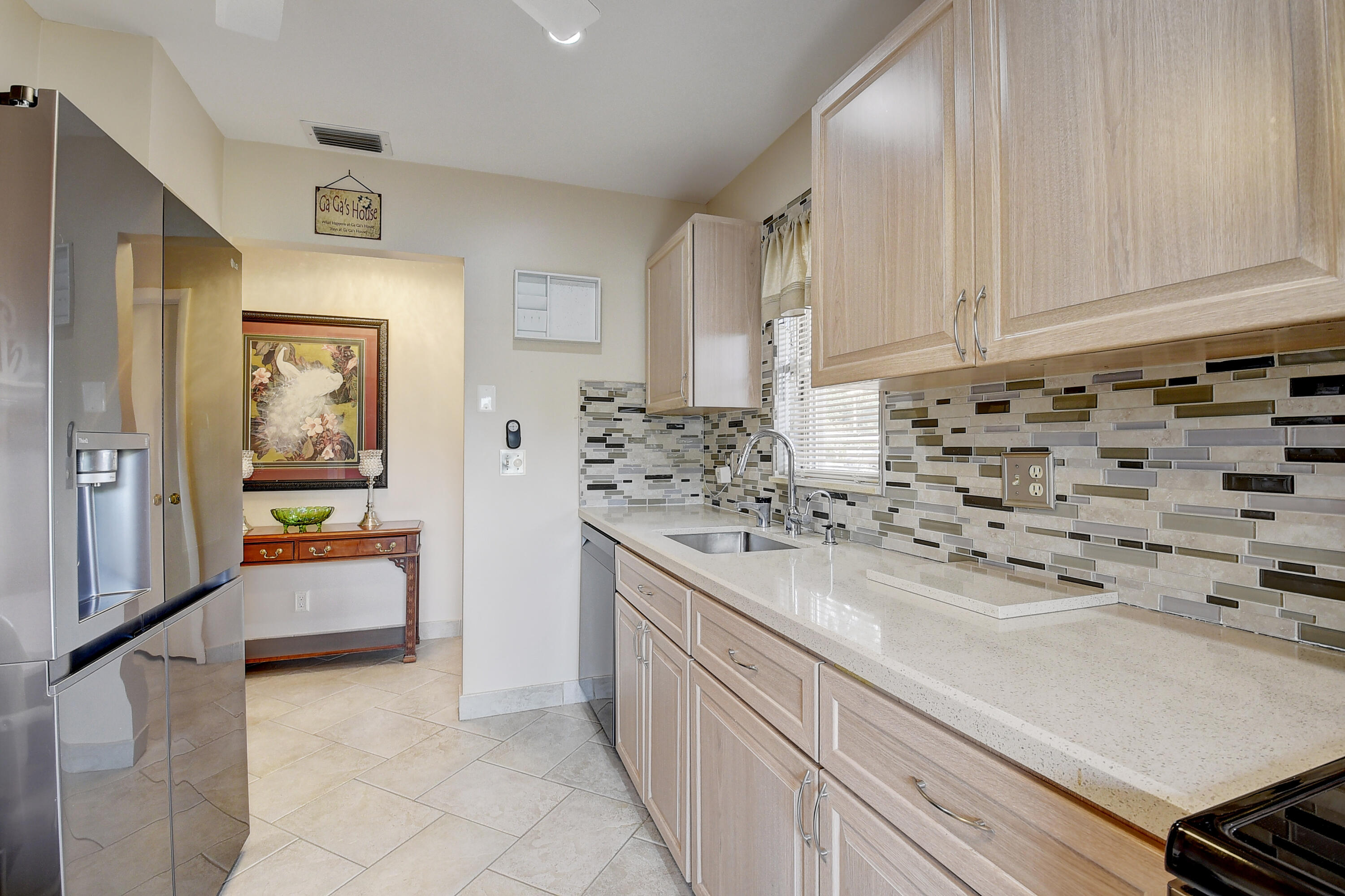 8936 Rheims Road Boca Raton, FL 33496 - Photo 15 of 42 a kitchen with granite countertop a sink and cabinets