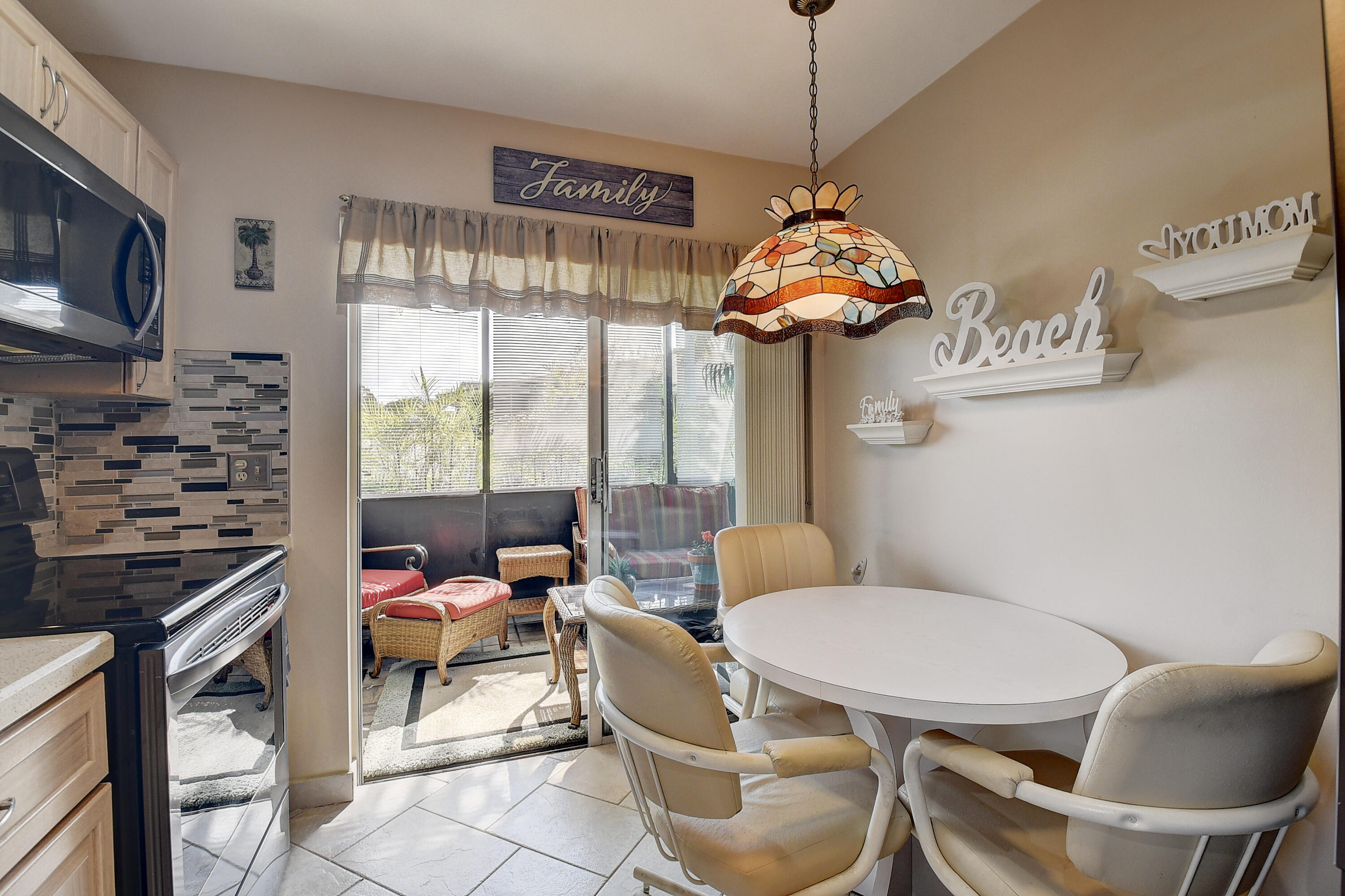 8936 Rheims Road Boca Raton, FL 33496 - Photo 16 of 42 a living room with furniture a flat screen tv and a floor to ceiling window