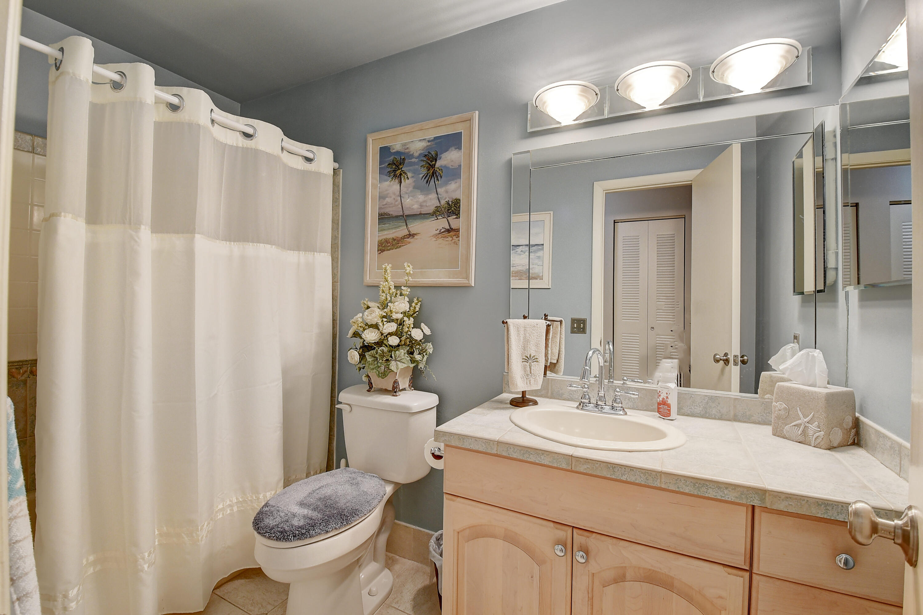 8936 Rheims Road Boca Raton, FL 33496 - Photo 19 of 42 a bathroom with a sink toilet and shower