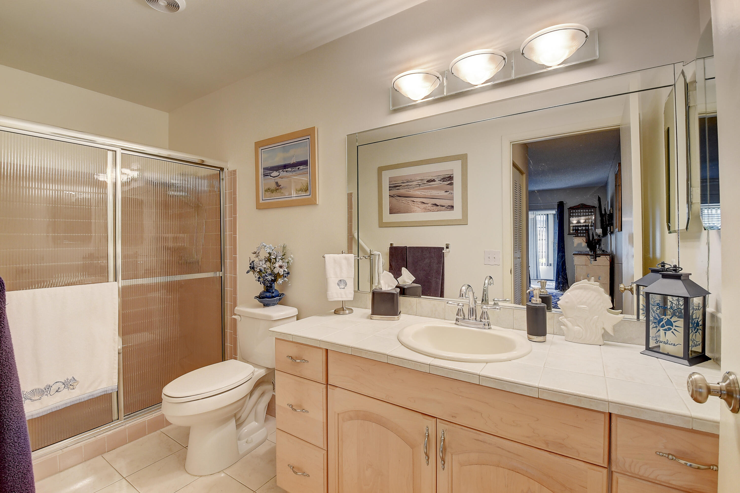 8936 Rheims Road Boca Raton, FL 33496 - Photo 22 of 42 a bathroom with a sink a toilet and shower
