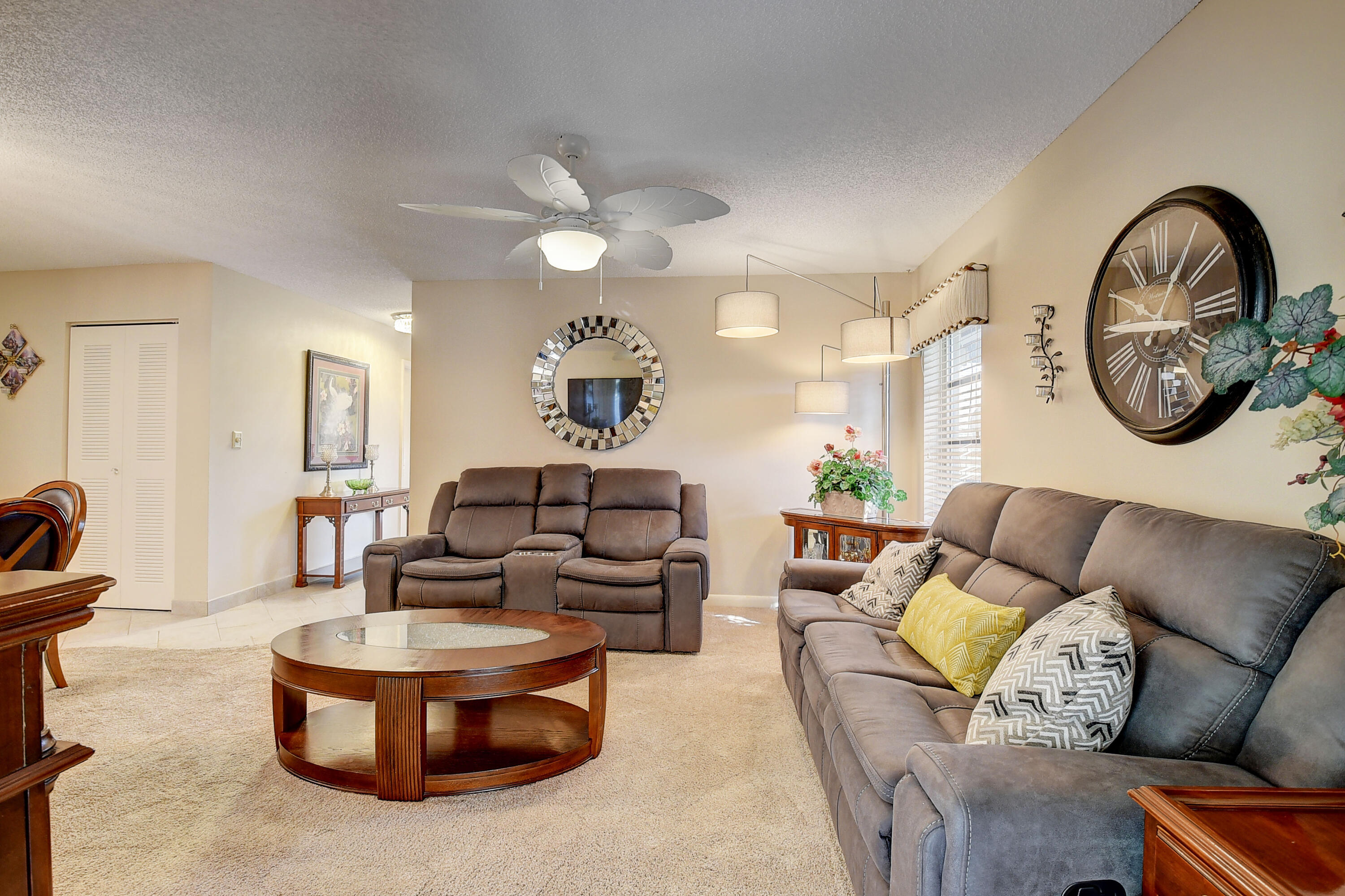 8936 Rheims Road Boca Raton, FL 33496 - Photo 10 of 42 a living room with furniture a rug a clock and a window