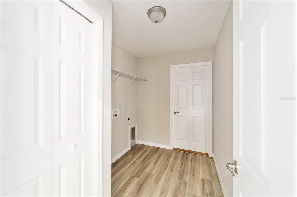 7866 North Manville Road Citrus Springs, FL 34434 - Photo 13 of 19 a view of a hallway with wooden floor