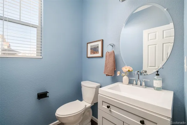 a white toilet sitting next to a bathroom sink
