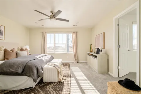 a bed room with a bed a couch and a window