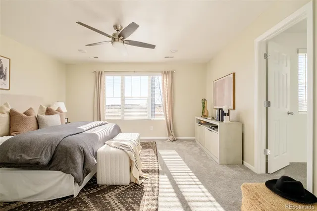 a bed room with a bed a couch and a window