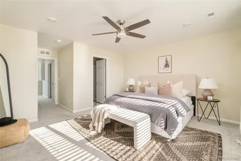 a bedroom with a bed and a chandelier