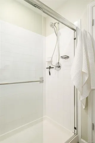 a bathroom with a shower and a glass door