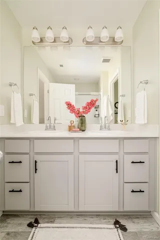 a bathroom with a sink vanity and a mirror