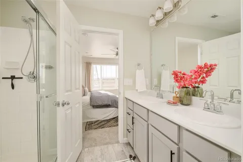 a bathroom with a granite countertop sink a shower and a mirror
