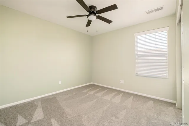 a view of a back yard with wooden fence