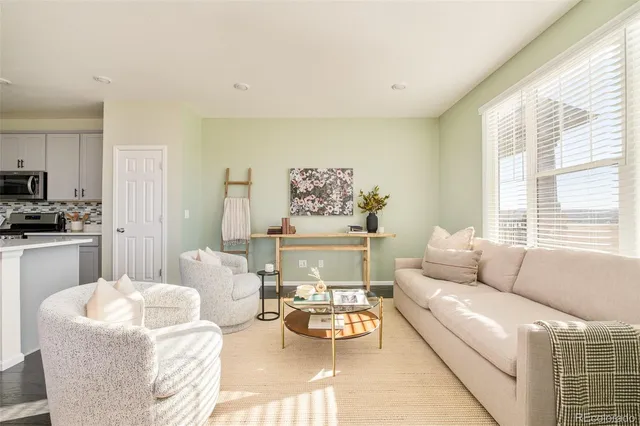 a living room with furniture and a large window