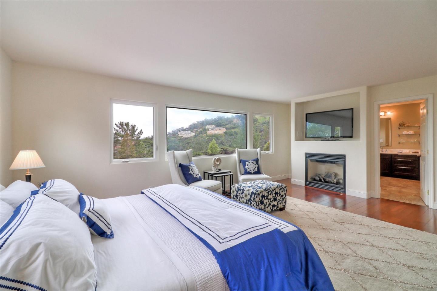 50 Tobin Clark Drive Hillsborough, CA 94010 - Photo 20 of 38 a bedroom with a bed and a fireplace