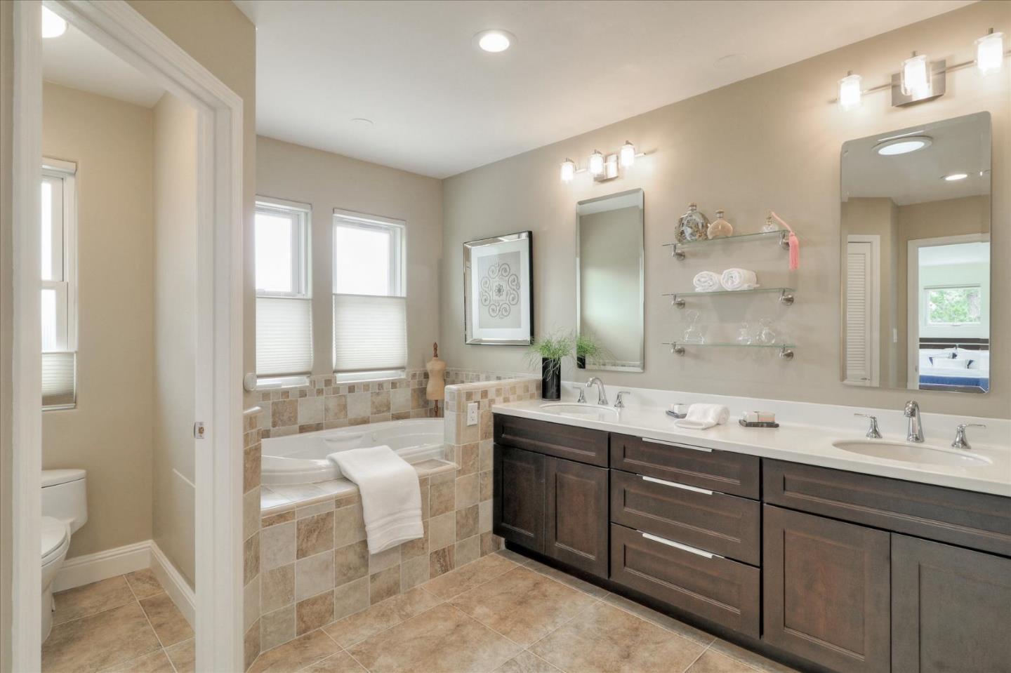 50 Tobin Clark Drive Hillsborough, CA 94010 - Photo 21 of 38 a spacious bathroom with a double vanity sink a large mirror and a bathtub