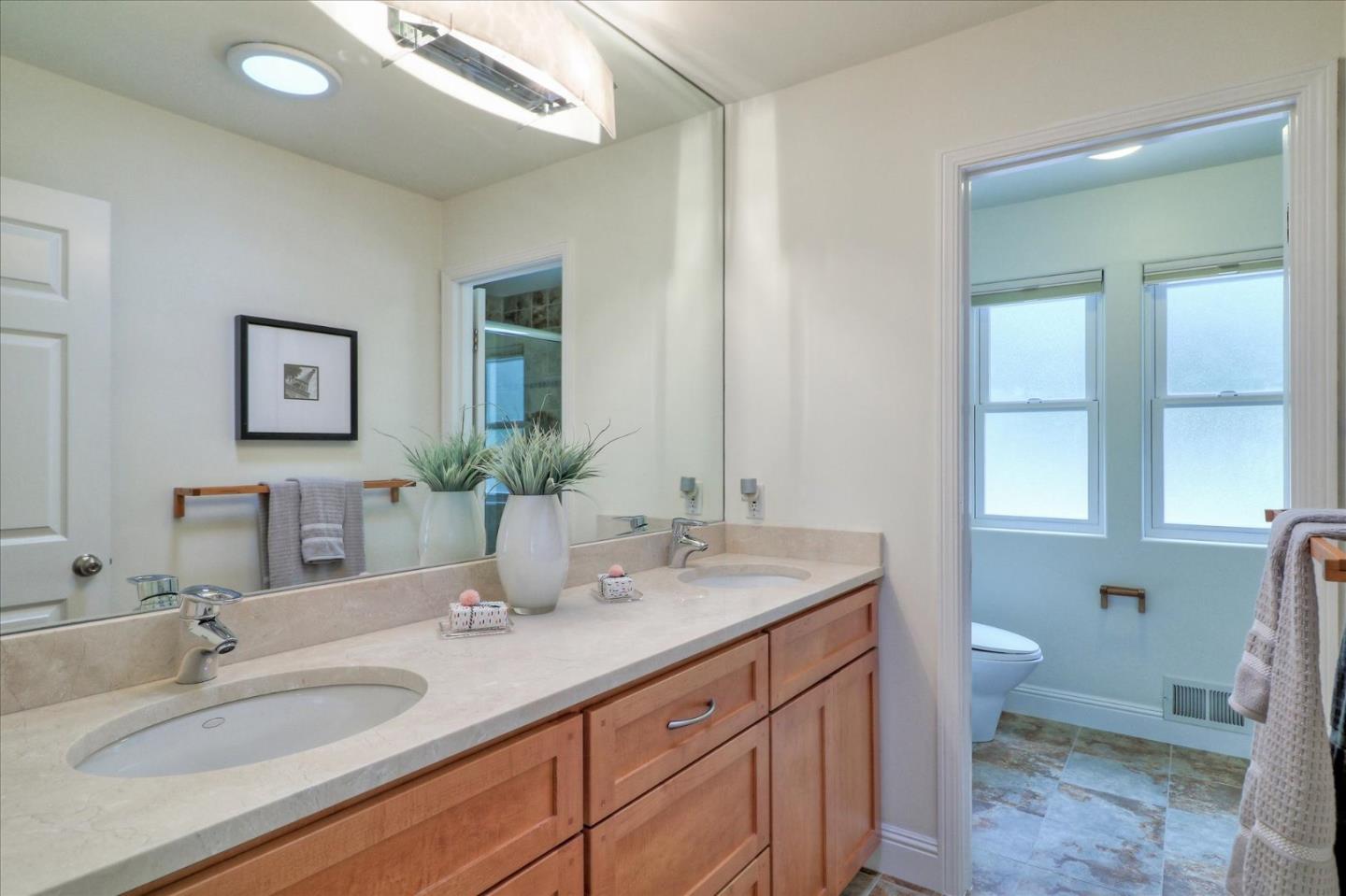 50 Tobin Clark Drive Hillsborough, CA 94010 - Photo 26 of 38 a bathroom with a granite countertop sink a toilet and a mirror