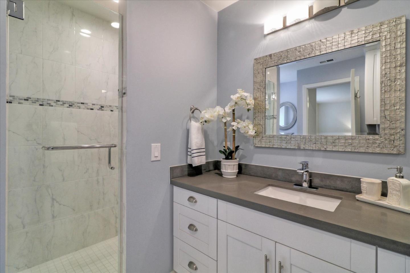 50 Tobin Clark Drive Hillsborough, CA 94010 - Photo 27 of 38 a bathroom with a double vanity sink and a mirror