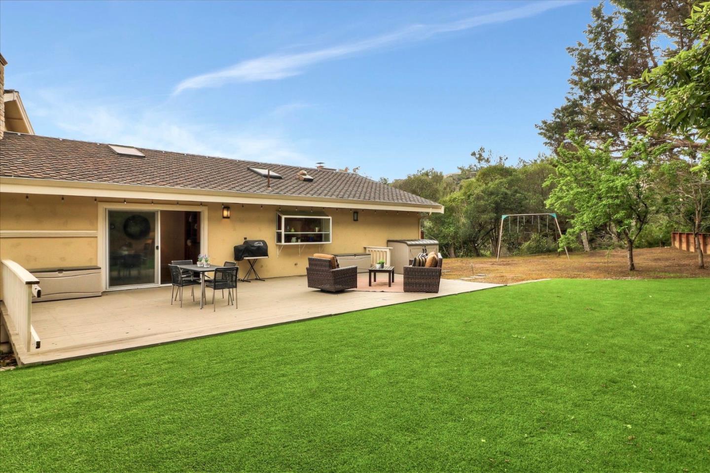 50 Tobin Clark Drive Hillsborough, CA 94010 - Photo 31 of 38 a view of a patio with table and chairs with wooden fence