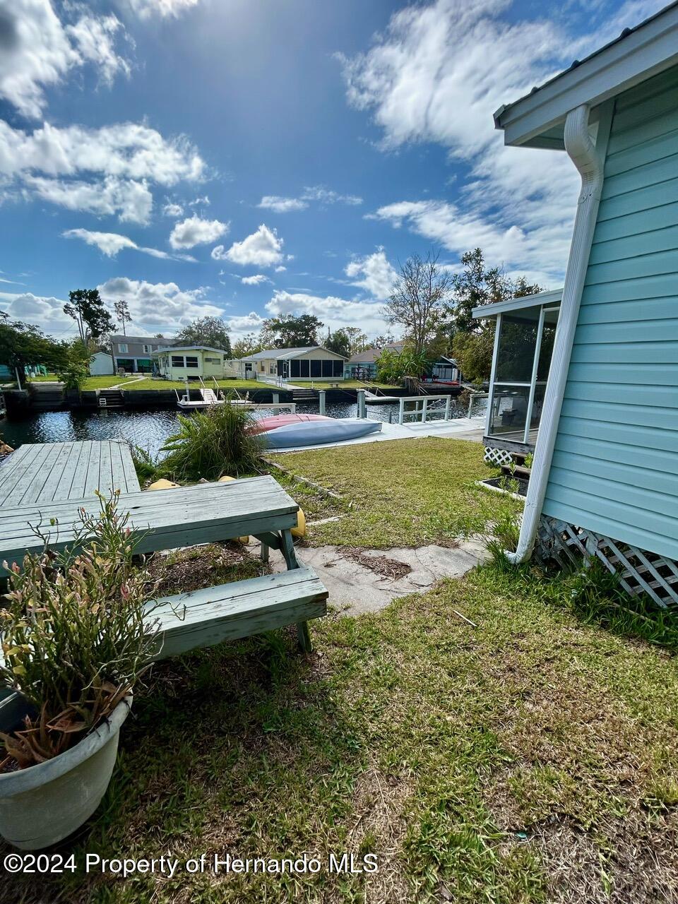 5332 Circle Drive Weeki Wachee, FL 34607 - Photo 13 of 27 a view of a swimming pool with outdoor seating and a garden