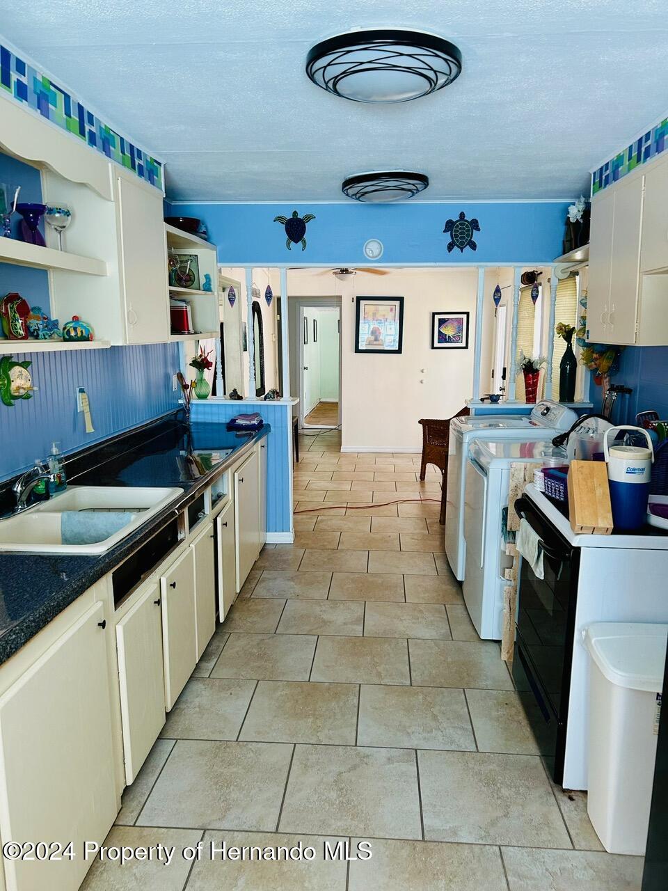 5332 Circle Drive Weeki Wachee, FL 34607 - Photo 17 of 27 a kitchen with stainless steel appliances granite countertop a sink stove and cabinets