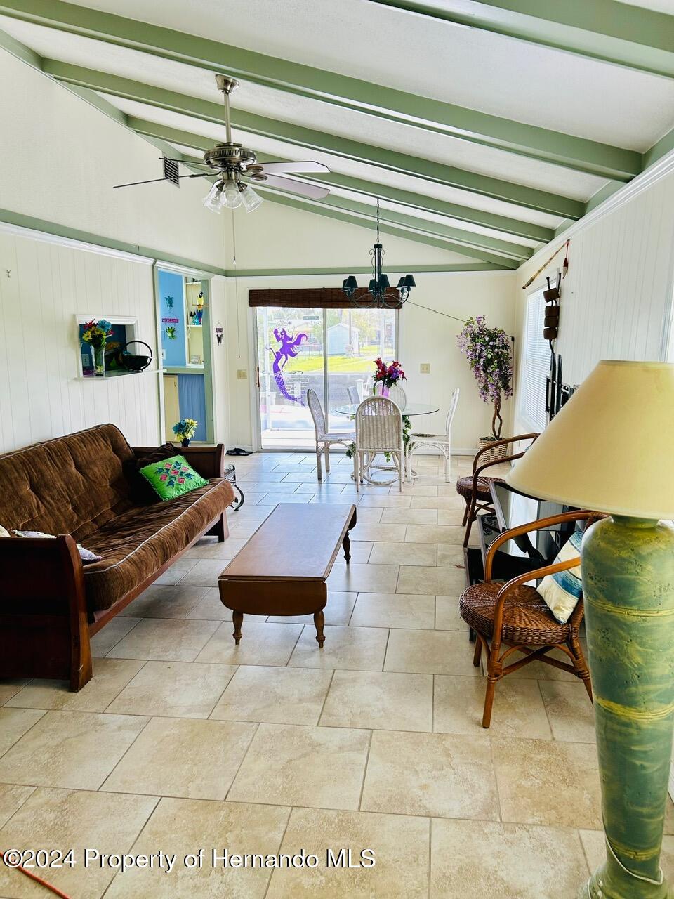 5332 Circle Drive Weeki Wachee, FL 34607 - Photo 19 of 27 a living room with furniture and a chandelier