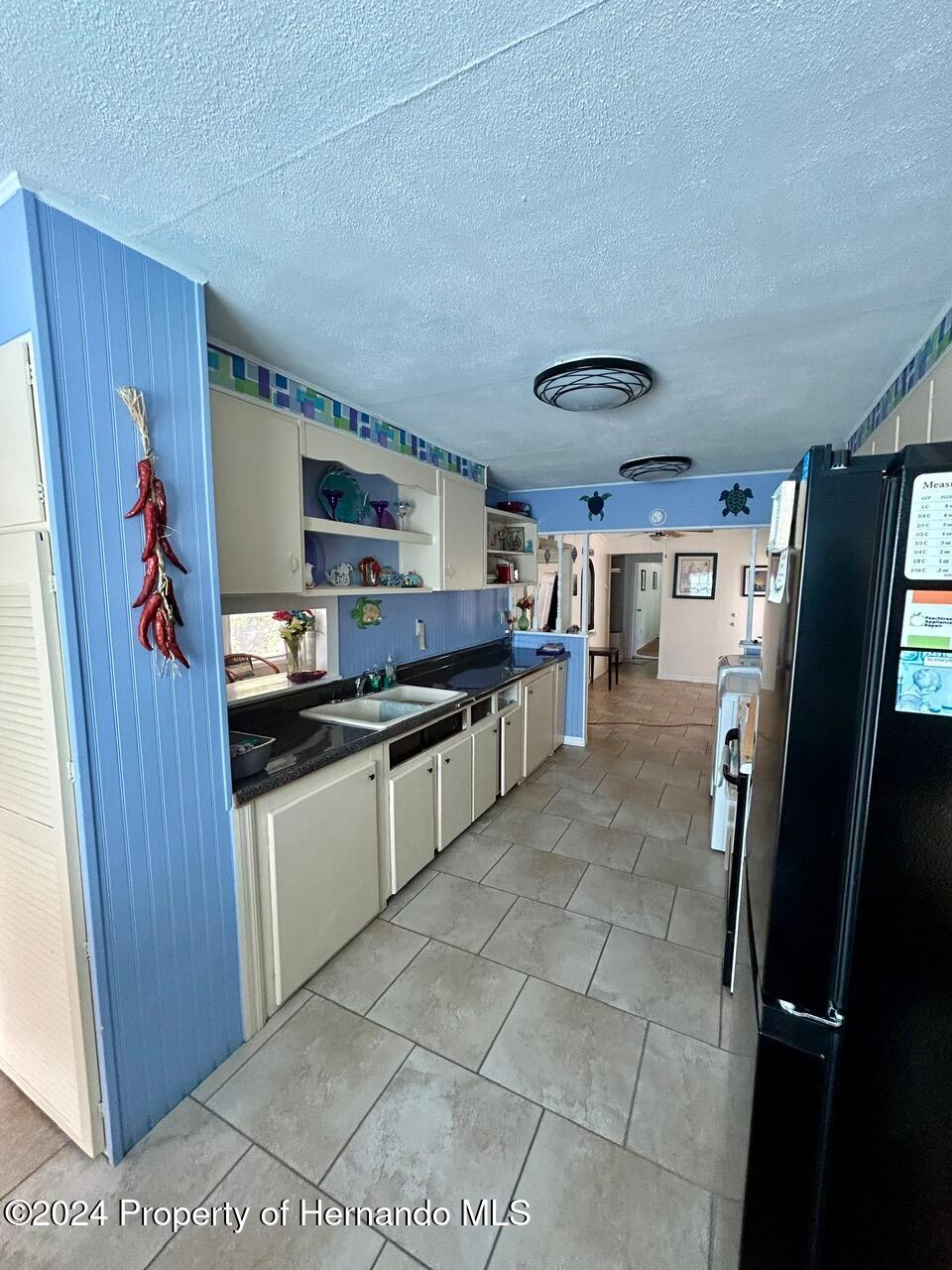 5332 Circle Drive Weeki Wachee, FL 34607 - Photo 22 of 27 a kitchen with stainless steel appliances granite countertop a refrigerator and a sink
