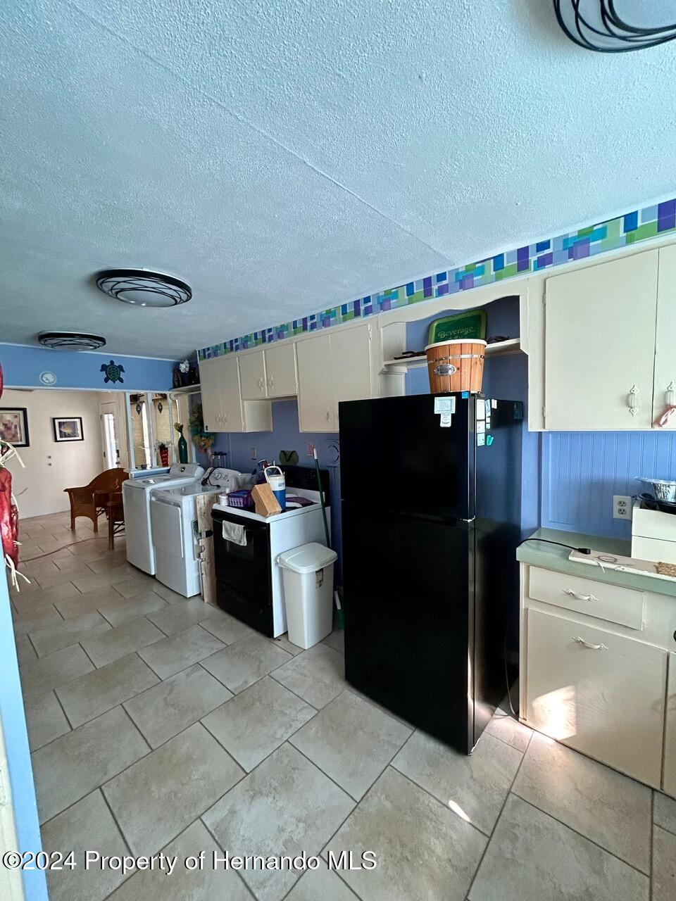 5332 Circle Drive Weeki Wachee, FL 34607 - Photo 23 of 27 a kitchen with stainless steel appliances a refrigerator and a stove