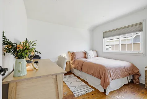 a bedroom with a bed and a potted plant