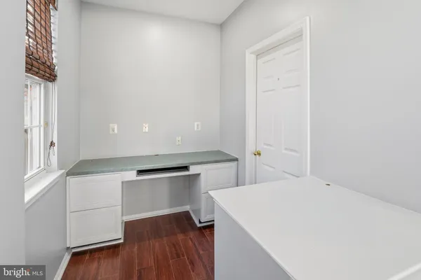 a view of an empty room with a window and fireplace