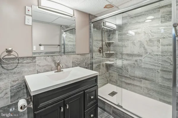 a bathroom with a sink a bathtub and a shower