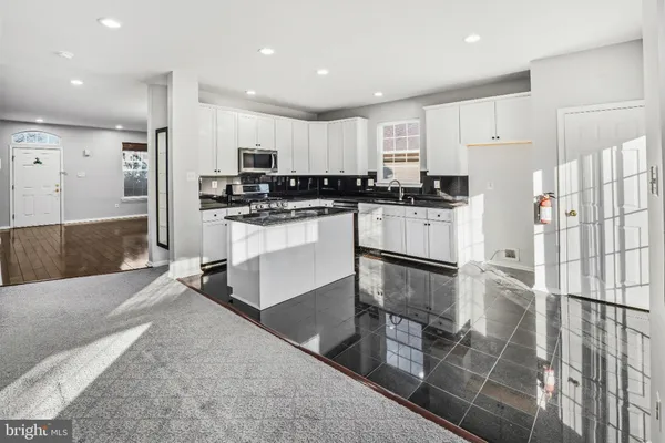 a kitchen with refrigerator and cabinets